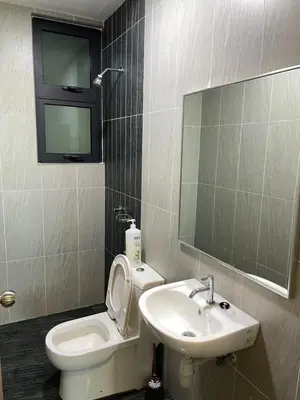a bathroom with a toilet and a sink and a mirror at Legasi Kampung Bharu by Tulip in Kuala Lumpur