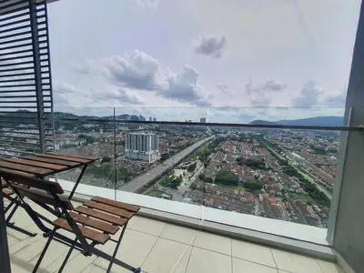a chair sitting on a balcony with a view of a city at United Point Residence 6 pax Near Mont Kiara Desa Park Kepong in Kuala Lumpur