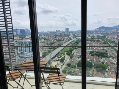 a balcony with two chairs and a view of a city at United Point Residence 6 pax Near Mont Kiara Desa Park Kepong in Kuala Lumpur