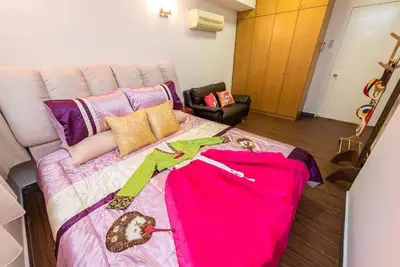 a bedroom with a large bed with a pink blanket at Fahrenheit88-Korea Theme Bukit Bintang Kuala Lumpur 2R2B 6Pax in Kuala Lumpur