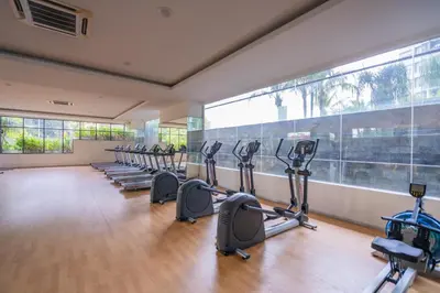 a gym with a row of treadmills and ellipticals at Peaceful 3-bedroom with Pool 5 pax - Wangsa Maju in Kuala Lumpur