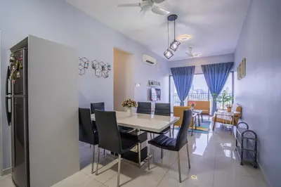 a kitchen and dining room with a table and chairs at Peaceful 3-bedroom with Pool 5 pax - Wangsa Maju in Kuala Lumpur