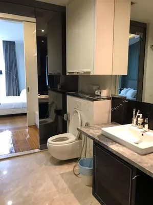 a bathroom with a white toilet and a sink at Platinum KLCC By Rainbow Suites in Kuala Lumpur
