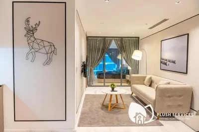 a living room with a drawing of a deer on the wall at Eaton Residences KLCC by Plush in Kuala Lumpur