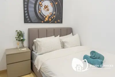 a bedroom with a bed with a blue towel on it at Eaton Residences KLCC by Plush in Kuala Lumpur