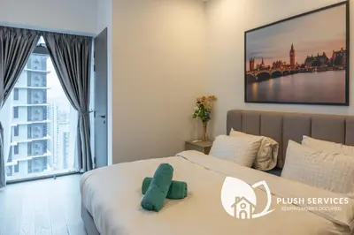a bedroom with a bed and a large window at Eaton Residences KLCC by Plush in Kuala Lumpur