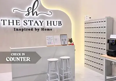 a sign for the stay hub in a store with stools at The Luxe & Colony KLCC Skyline Infinity Pool - 5min to Petronas Tower & KL City Center by The Stay Hub in Kuala Lumpur