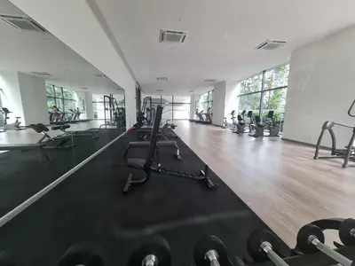 a gym with several treadmills and exercise machines at Bangsar South Apartment by Sarah's Lodge @ SouthLink Lifestyle Apartment in Kuala Lumpur