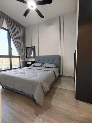 a bedroom with a large bed with a ceiling fan at Bangsar South Apartment by Sarah's Lodge @ SouthLink Lifestyle Apartment in Kuala Lumpur