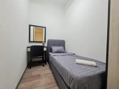 a bedroom with a bed and a chair and a mirror at Bangsar South Apartment by Sarah's Lodge @ SouthLink Lifestyle Apartment in Kuala Lumpur