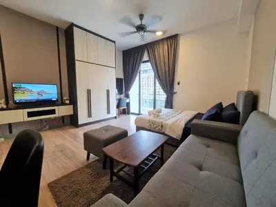 a living room with a couch and a tv at Bangsar South Apartment by Sarah's Lodge @ SouthLink Lifestyle Apartment in Kuala Lumpur