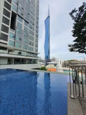 a pool in the middle of a city with tall buildings at Robertson Suites Bukit Bintang with Netflix in Kuala Lumpur