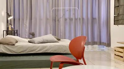 a bedroom with a bed and two chairs in front of a window at Flexi check in 10min to KLCC next to Hospital Gleneagle in Kuala Lumpur