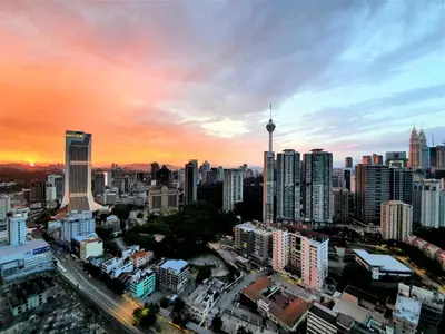 a city skyline at sunset with a lot of tall buildings at Eclipse Suites Robertson Bukit Bintang in Kuala Lumpur