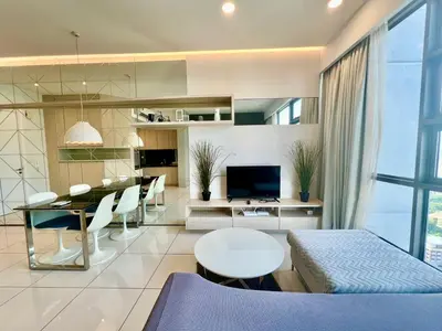 a living room with a table and a dining room at Eclipse Suites Robertson Bukit Bintang in Kuala Lumpur