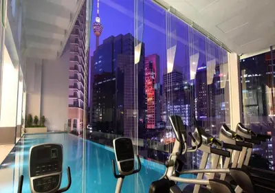 a gym with a view of a city skyline at 2BR Tourists-Friendly Oasis - Heart of the City KL by Verano in Kuala Lumpur