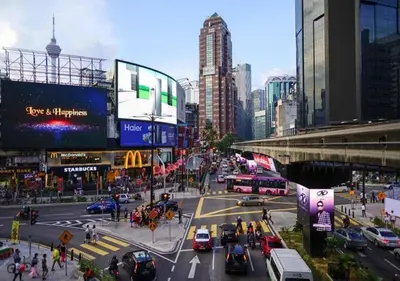 a busy city street with cars and people and buildings at 2BR Tourists-Friendly Oasis - Heart of the City KL by Verano in Kuala Lumpur