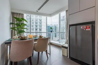 a dining room with a table and chairs and a large window at 2BR Tourists-Friendly Oasis - Heart of the City KL by Verano in Kuala Lumpur