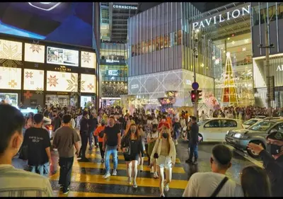 a crowd of people walking down a busy city street at Starlight Penthouse 6-12Pax, 600m to Pavilion KL by Verano in Kuala Lumpur