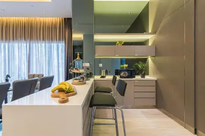 a kitchen with a white counter and chairs at Starlight Penthouse 6-12Pax, 600m to Pavilion KL by Verano in Kuala Lumpur