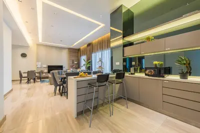 a kitchen and dining room with a bar and chairs at Starlight Penthouse 6-12Pax, 600m to Pavilion KL by Verano in Kuala Lumpur