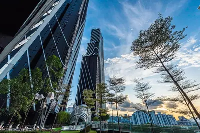 two tall buildings in a city with trees in front at Urban Duplex v Balcony- 2R2B Up to 7Pax, MontKiara by Verano in Kuala Lumpur