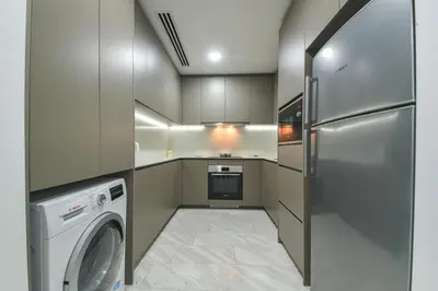 a kitchen with a washer and dryer in it at Eaton Residence KLCC in Kuala Lumpur