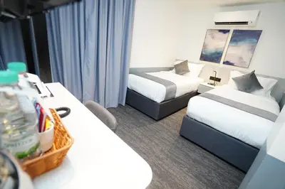 a hotel room with two beds and a couch and a bed and a table at Dê MOCCIS Boutique Hotel in Kuala Lumpur