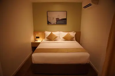 a bedroom with a bed and a picture on the wall at Dê MOCCIS Boutique Hotel in Kuala Lumpur