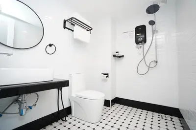 a bathroom with a toilet and a sink and a mirror at Dê MOCCIS Boutique Hotel in Kuala Lumpur