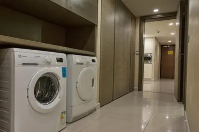 a washer and dryer in a laundry room at Ascott Sentral Kuala Lumpur in Kuala Lumpur
