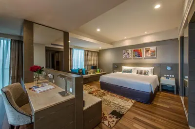 a hotel room with a bed and a desk at Ascott Sentral Kuala Lumpur in Kuala Lumpur
