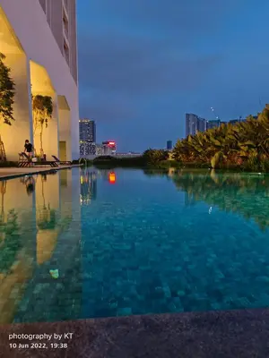 a swimming pool with a city skyline in the background at UNA Serviced Apartment by manatidur in Kuala Lumpur