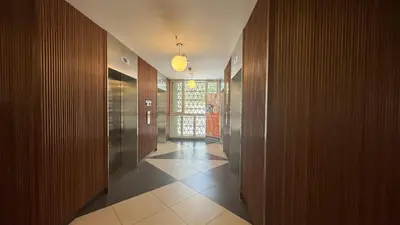 a hallway with wooden walls and a hallway with a hallway at UNA Serviced Apartment by manatidur in Kuala Lumpur