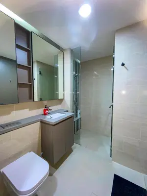a bathroom with a toilet and a sink and a shower at Eaton Residence KLCC by Yemala in Kuala Lumpur