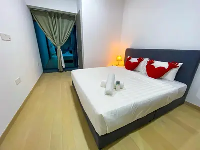 a bedroom with a large bed with red pillows at Eaton Residence KLCC by Yemala in Kuala Lumpur