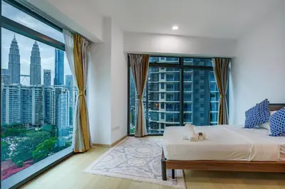 a bedroom with a bed and a large window at Eaton Residence KLCC by Yemala in Kuala Lumpur