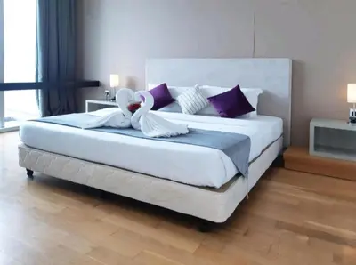 a bedroom with a large bed with a stuffed animal on it at The Platinum KLCC By Crystal in Kuala Lumpur
