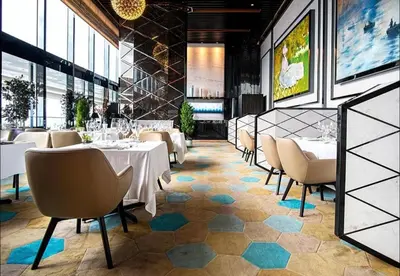 a dining room with white tables and chairs and windows at The Platinum KLCC By Crystal in Kuala Lumpur