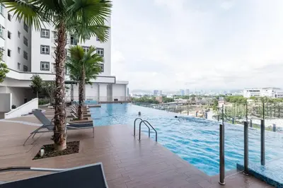 a swimming pool with palm trees on a building at TR Residence Lovely 3 BR unit 6pax next to Titiwangsa LRT in Kuala Lumpur