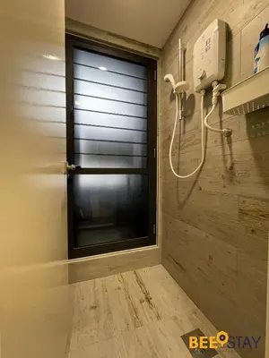 a bathroom with a window and a shower at Arte Mont Kiara Studio by BeeStay in Kuala Lumpur