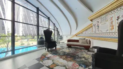 a living room with a couch and a table at Arte Mont Kiara Studio by BeeStay in Kuala Lumpur