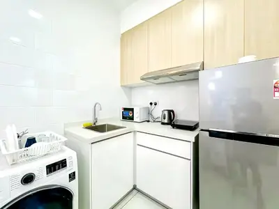 a white kitchen with a sink and a dishwasher at Arte Mont Kiara Kuala Lumpur in Kuala Lumpur