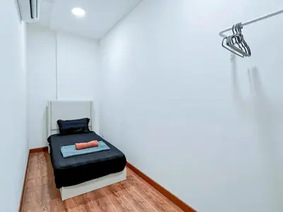 a small room with a black bed in a white room at Arte Mont Kiara Kuala Lumpur in Kuala Lumpur