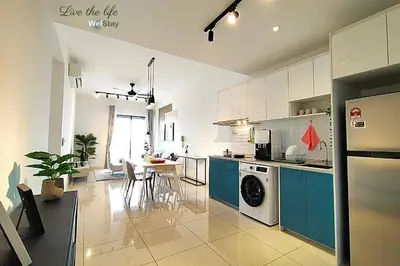 a kitchen with blue cabinets and a washer at Awesome Designer Suite 3-Beds Near TRX KLCC, Next to IKEA in Kuala Lumpur