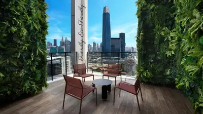 a room with chairs and a table with a view of the city at Awesome Designer Suite 3-Beds Near TRX KLCC, Next to IKEA in Kuala Lumpur