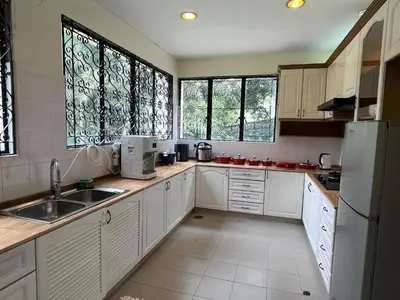 a kitchen with white cabinets and a sink and windows at Bukit Tunku KLCC Grande Villa 11 by Vale Pine in Kuala Lumpur