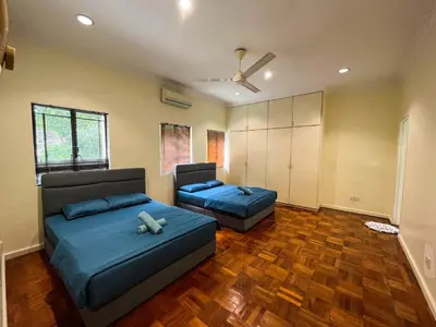 a living room with two beds and a closet at Bukit Tunku KLCC Grande Villa 11 by Vale Pine in Kuala Lumpur
