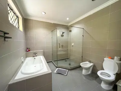 a bathroom with a shower and a toilet and a sink at Bukit Tunku KLCC Grande Villa 11 by Vale Pine in Kuala Lumpur