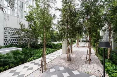 a courtyard with trees in a building at Una serviced Apartment in Kuala Lumpur
